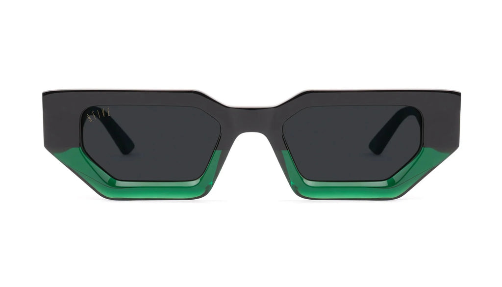 Geometric square sunglasses with a matte black frame and translucent green acetate detailing along the bottom edges of the lenses, shown against a plain white background.